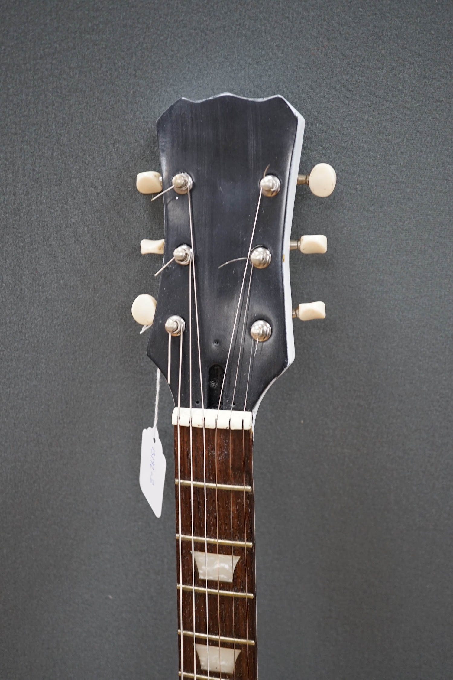 A white painted electric six string guitar